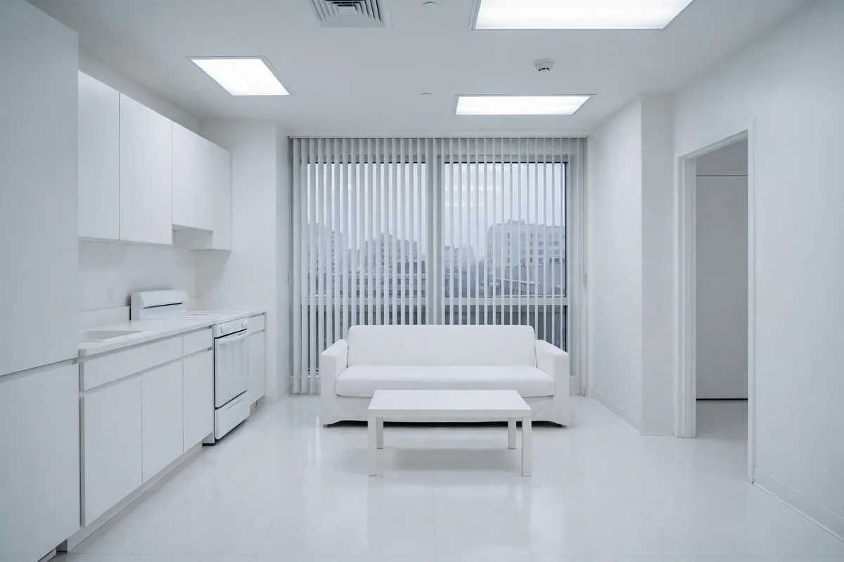 Sterile all-white apartment living room feeling cold like a hospital waiting room