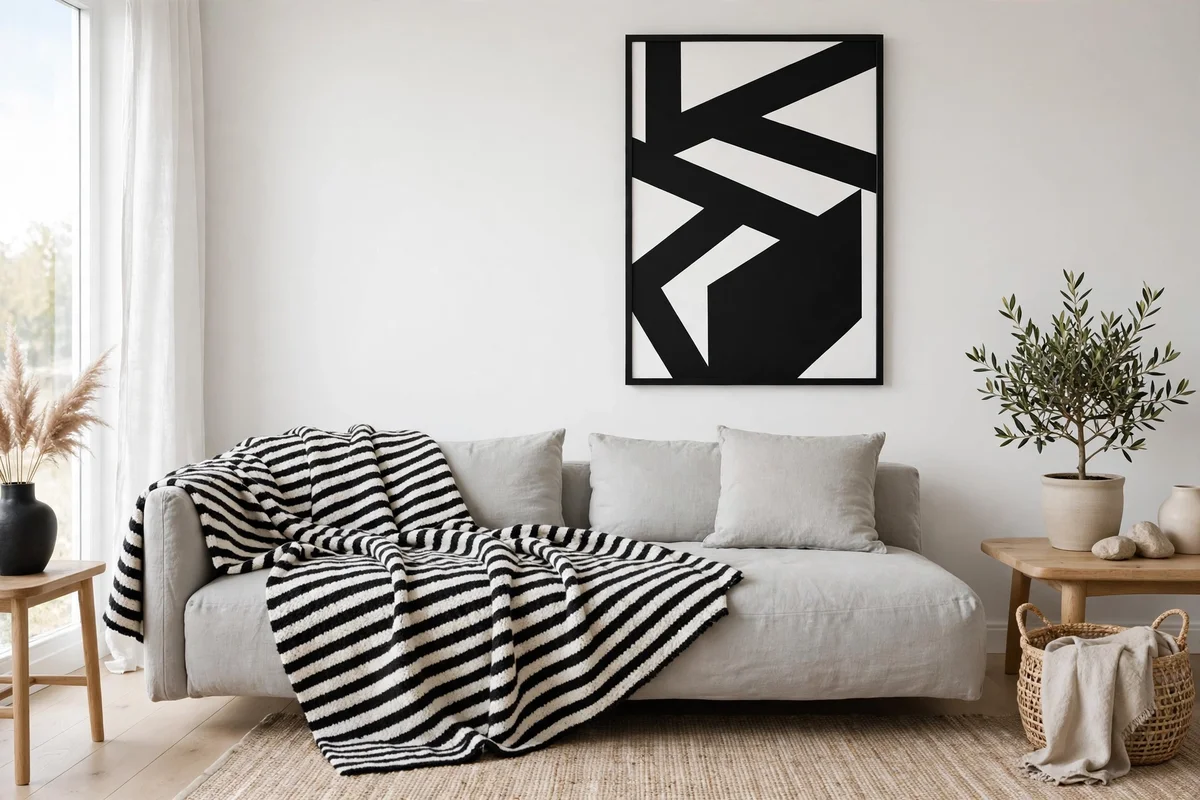 Black-and-white graphic throw adding contrast in a Scandinavian living room